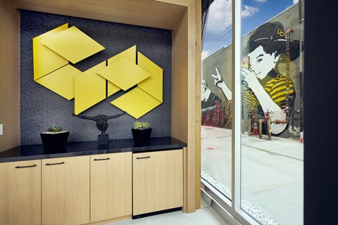 a wall with yellow triangles and a picture of a woman on it